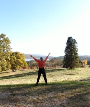 fall landscape with person holding up arms