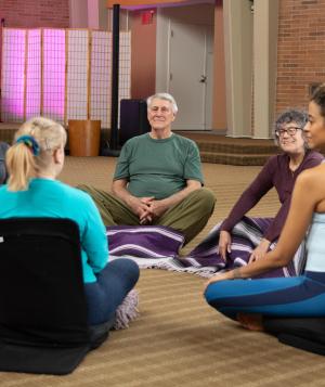 Group of people seated in a share circle
