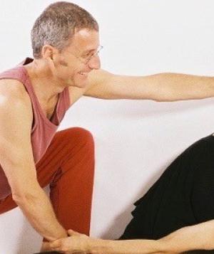 Daniel Lansky and a partner demonstrating assisted stretching