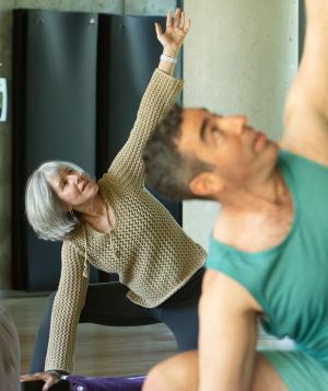 Group of people practicing active yoga indoors