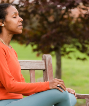 a person sitting on a bench outside